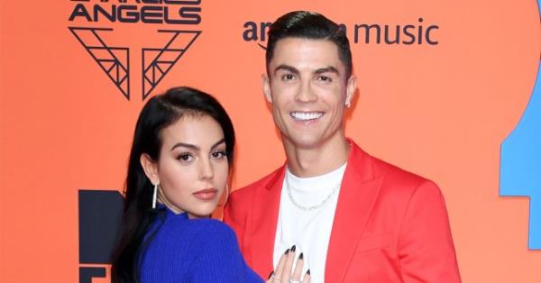 Georgina Rodriguez and Christiano Ro<em></em>naldo attending an event. Georgina is wearing a blue dress while Christiano wears a white t-shirt and a red blazer