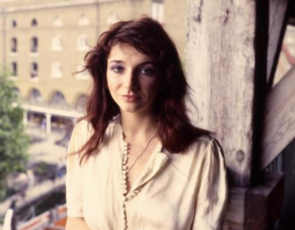 Kate Bush poses for the camera in a white blouse in the 1970s