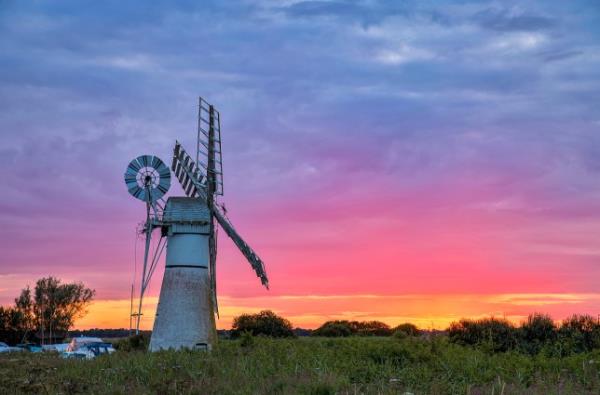 Sunset over a windmill in Thurne, Norfolk, United Kingdom