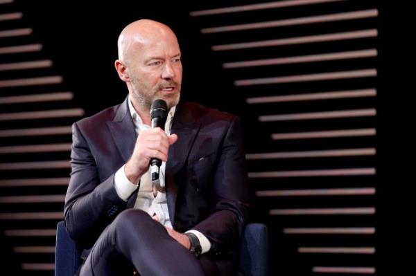 Alan Shearer pictured speaking with a microphone