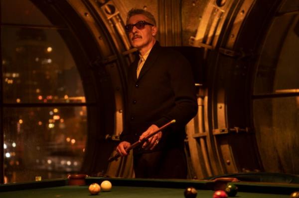 John Turturro as Carmine Falcone in The Batman, holding a snooker cue over a pool table