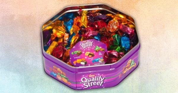 A box of Quality Street chocolates in purple branded tin