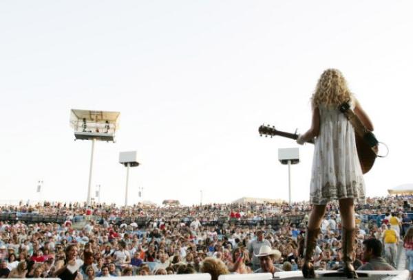 Taylor Swift performs to huge crowd in Kansas City on May 11, 2007. She is pictured from behind, looking out over the crowd.