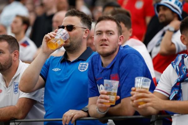 A picture of English football fans drinking in the stands during a match