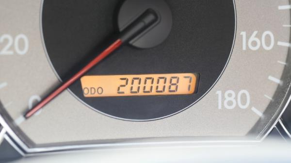 A closeup photo of a car's dashboard odometer