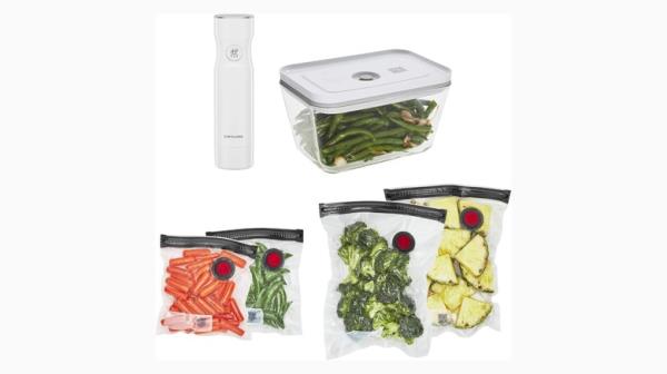 Small white handheld device alo<em></em>ngside a food co<em></em>ntainer and bags co<em></em>ntaining food