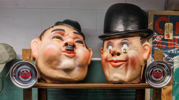 Laurel and Hardy masks on shelf at Antique Archaeology store in Iowa