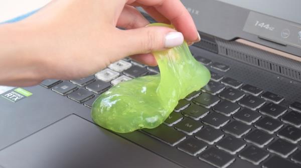 Using cleaning gel on a laptop keyboard.