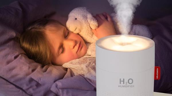 Humidifier with sleeping child holding a lamb stuffed animal