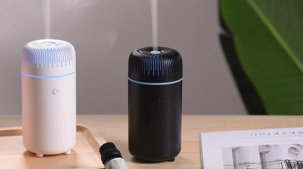 Black and white humidifiers on a table