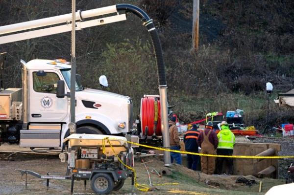 Rescue workers co<em></em>ntinue to search, Wednesday, Dec. 4, 2024, for Elizabeth Pollard, who is believed to have disappeared in a sinkhole while looking for her cat, in Marguerite, Pa. (AP Photo/Gene J. Puskar)