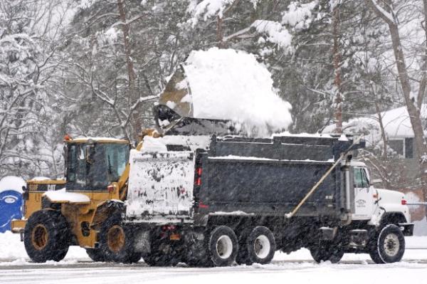 Snow is cleared from a Highmark Stadium parking lot for a Sunday Night Football game between the Buffalo Bills and the San Francisco 49ers on Sunday, Dec. 1, 2024 in Orchard Park, NY.(AP Photo/Gene J. Puskar)