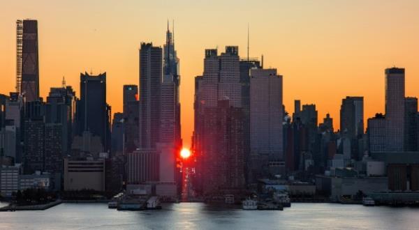 The sun rises over 42nd Street during a sunrise Manhattanhenge or reverse Manhattanhenge as it is also known in New York City on November 30, 2024, as seen from Weehawken, New Jersey. (Photo by Gary Hershorn/Getty Images)