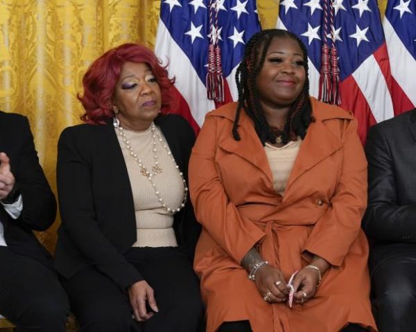 Shaye Moss, a former Georgia election worker, right, and her mother, Ruby Freeman, are pictured during a ceremony to mark the second anniversary of the Jan. 6 assault on the Capitol and to award Presidential Citizens Medals in the East Room of the White House in Washington, Friday, Jan. 6, 2023. (AP Photo/Patrick Semansky)