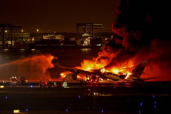 Firefighters work at Haneda Airport on Jan. 2 after a Japan Airlines' A350 airplane caught fire following a collision with a Japan Coast Guard plane en route to deliver supplies to quake-stricken Noto Peninsula.