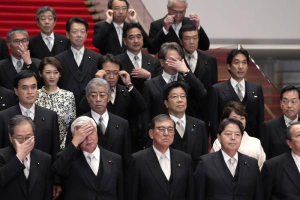 Prime Minister Shigeru Ishiba (center) poses for a group photograph with the members of his new Cabinet at the Prime Minister’s Office on Oct. 1. After Fumio Kishida announced in August he would step down from the top job in September, Ishiba won a leadership vote before suffering a resounding defeat in a natio<em></em>nal poll that resulted in the loss of his Liberal Democratic Party’s Lower House majority.