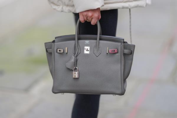 Diane Batoukina holding a grey leather Birkin Hermes bag during a street style fashion photo session in Paris, France on December 18, 2024.