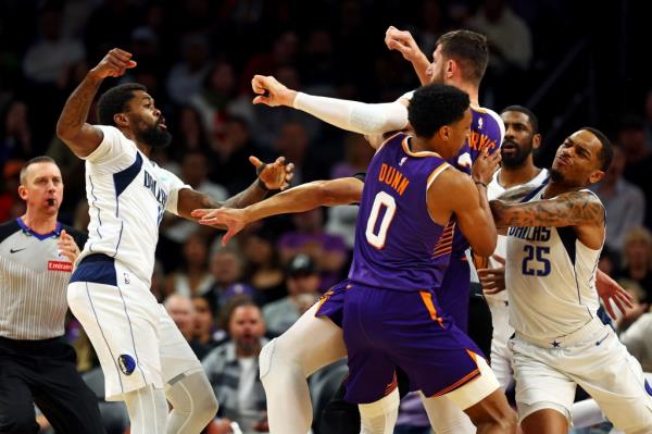 Dallas Mavericks forward Naji Marshall (13) punches Phoenix Suns center Jusuf Nurkic (20) during the third quarter at Footprint Center. 