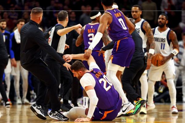 Phoenix Suns center Jusuf Nurkic (20) falls after being punched by Dallas Mavericks forward Naji Marshall (not pictured) during the third quarter at Footprint Center. 