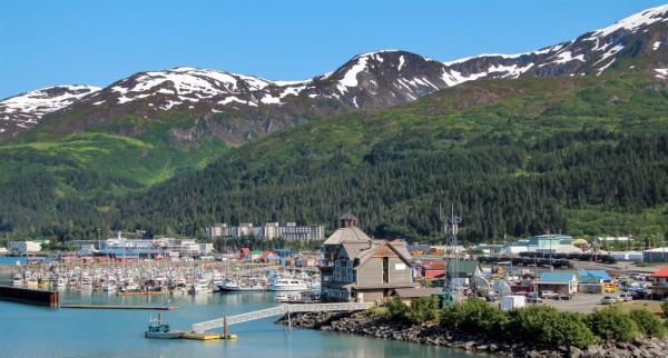 Small city of Whittier, Alaska, nestled between a body of water and mountainous terrain, showcasing captivating remote views