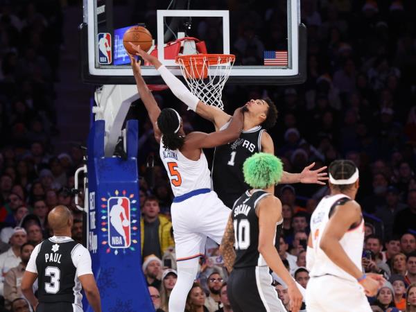 Knicks forward Precious Achiuwa #5 puts up a shot as San Anto<em></em>nio Spurs center Victor Wembanyama #1 defends