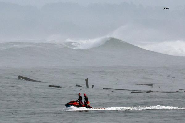 Debris from a wharf collapse litters the ocean Monday, Dec. 23, 2024, in Santa Cruz, Calif.