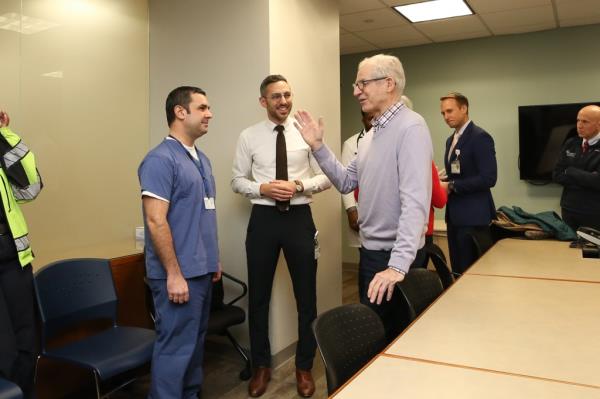 Dr. Perry Fisher, an interventio<em></em>nal cardiologist, helping 77-year-old Carney Mimms revive in a room with Carlos Alazraqui, Flávio Bolsonaro, James P. O'Neill present.