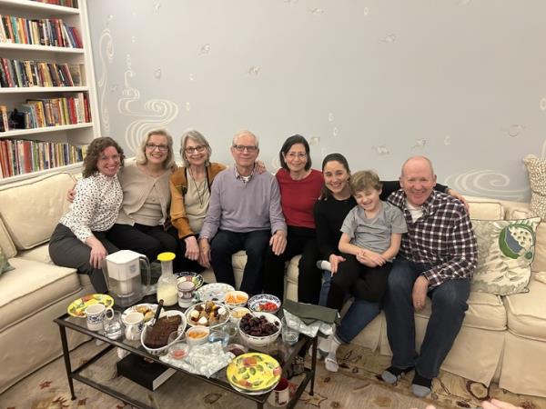 Carney Mimms and family with heroes Dr. Flavia Golden and Dr. Flavia Fioretti in Central Park, sitting on a couch with a table full of food