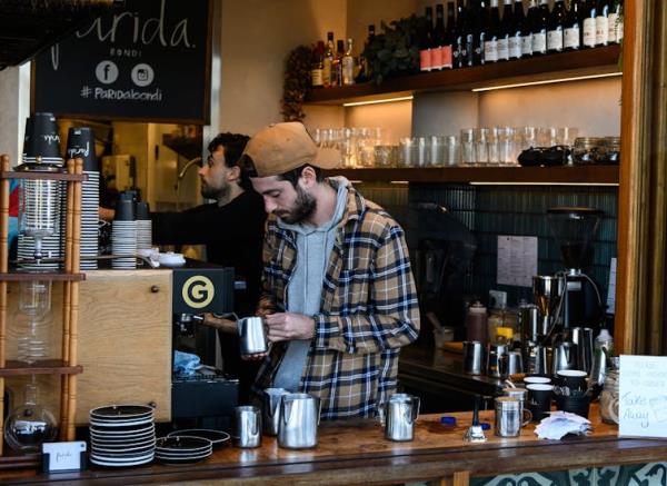 Barista at a coffee machine in a cafe