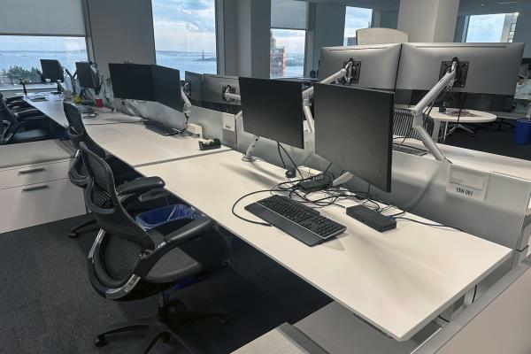 Empty desks are in an office building.