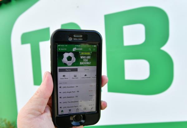 The TAB betting app is seen on a mobile phone outside a Tabcorp venue